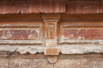 Roughly painted old orange wall with part of a shabby frame. Beautiful abstract grunge stucco wall background.