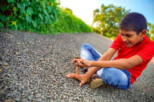 indian child playing with stone