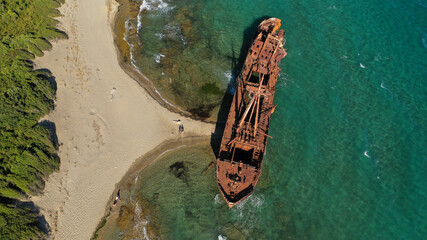 Aerial drone photo of abandoned shipwreck left to rust in Mediterranean island bay