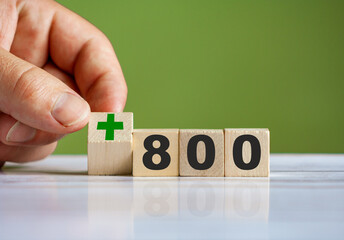 The hand turn wooden block with plus sign and set text "+800".