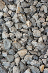 small road stone background, dark gravel pebbles stone texture. Closeup top view gravel. Gravel in garden. Pattern