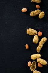 Peanut on black background. Space for text with concept nutrition.
