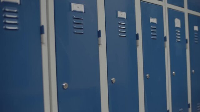 Row Of Blue Metal Lockers In The School Hallway. School Lockers. - close up shot (sideways)