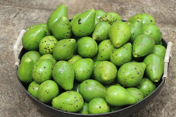 Avocado fruit also known by name butterfruit in a basket