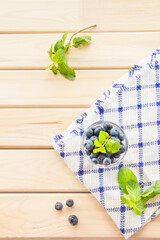  Juicy and fresh blueberries with green leaves. Creative atmospheric decoration