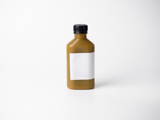 brown pastel color drink in plastic bottle container with empty logo label. mixed many vegetables and fruits smoothie juice on studio background.