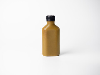 brown pastel color drink in plastic bottle container with empty logo label. mixed many vegetables and fruits smoothie juice on studio background.