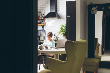 Young beautiful woman working at her home office