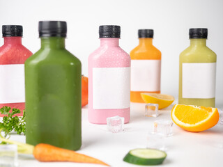 many pastel color drink in plastic bottle container with empty logo label. mixed many vegetables and fruits smoothie juice on studio  background.