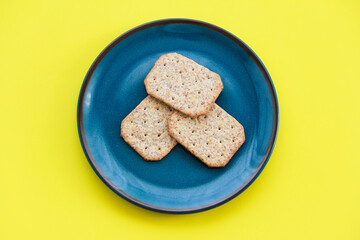 square dry grain cookies in a decorative plate