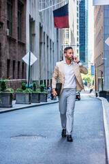 European Businessman traveling, working in New York City, with beard, little gray hair, wearing...