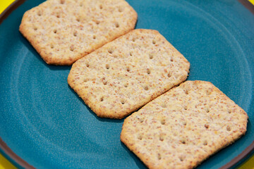 square dry grain cookies in a decorative plate