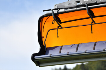 Orange cable car with seats and windshield