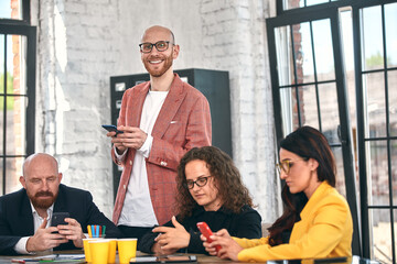 Shot of a group of young business professionals having a meeting. Diverse group of young designers smiling during a meeting at the office.