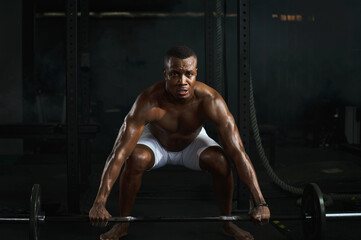 Fototapeta na wymiar Fit muscular male bodybuilder train deadlift lifting with barbells in gym fitness