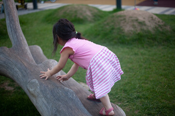 The girl is climbing a tree. 