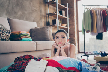 Photo of pretty stressed crying lady stay home quarantine lying many clothes heap stack floor...