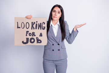 Photo of attractive fired upset manager lady hold carton placard seek job agree to accept any offer work proposition shrug shoulders formalwear plaid suit isolated grey color background