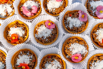 Fruit dessert with nuts on pastry basket. Variety of snacks. View from the top. Closeup.