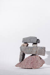 Big concrete stones folded into a pyramid concept on white background isolated with deep shadow. Free copy space