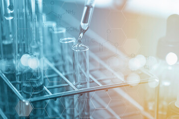 Closeup of Scientists use a chemical dropper into a test tube during an experiment in a science laboratory.
