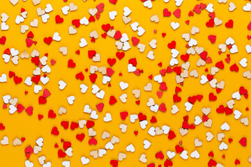 Happy Valentines day background. With small color hearts on yellow background.