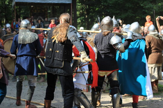knight's battle, people with shields, swords, spears in knight's armor