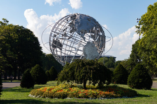 Unisphere Globe at Flushing Meadows Corona Park during Summer with Beautiful Flowers and Trees on July 29, 2020 in Queens, New York