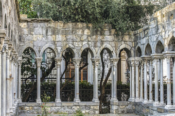 12th century Ruins of old cloisters standing in a small garden in Genoa, Italy.