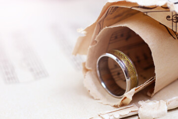 Gold wide ring and paper musical notes