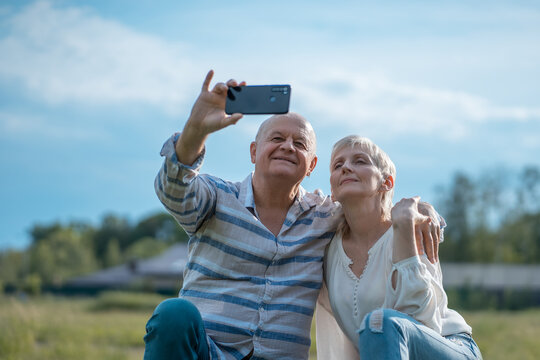 happy senior couple dating, taking selfie and have fun outdoor