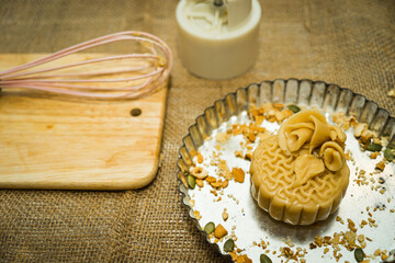 the wooden mold for moon cake, homemade cantonese moon cake pastry on baking tray before baking for traditional festival.
