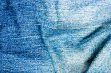 clothing items blue stonewashed faded jeans cotton fabric texture with seams, clasps, buttons and...