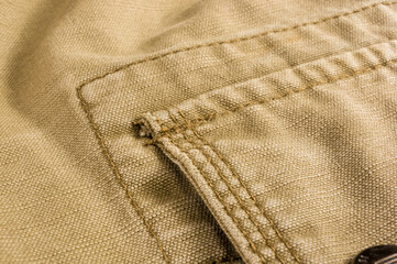 Fototapeta na wymiar clothing items stonewashed cotton fabric texture with seams, clasps, buttons and rivets, macro