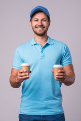 Happy delivery man with a two cups of coffee