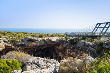 Viewpoint above karst sinkhole named Cehennem (Hell), Kizkalesi, Turkey. It's one of deepest sinkholes in Turkey. Its depth about 128 m, square about 70x50 m. Mediterranean sea is on background