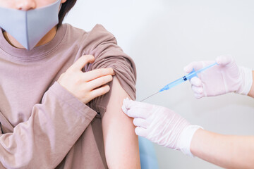 corona virus vaccine injection to young woman