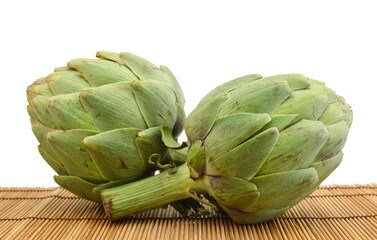 Obraz premium Green artichoke on bamboo mat