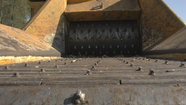 Industrial shredder conveyor being used in a logging forest 