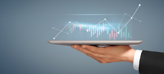 Businessman plan graph growth  increase of chart positive indicators in his business, tablet in hand