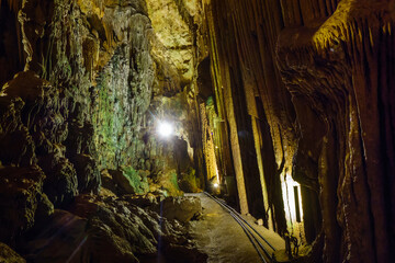 Walking gallery inside underground karst cave Astim or Asthma, Kizkalesi, Turkey. Cave attractive for tourists for its formations such as stalactites & stalagmites, formed by water drops for centuries