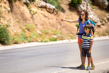 Woman with a child hitchhiking, The girl catches the car