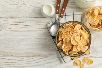 Concept of breakfast with muesli and milk on white wooden table