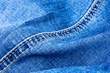 clothing items blue stonewashed faded jeans cotton fabric texture with seams, clasps, buttons and...