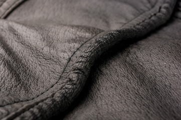 Old vintage genuine soft black leather texture background, top layer with pores and scratches,...