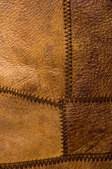 Old vintage genuine soft brown leather texture background, top layer with pores and scratches, macro, close-up