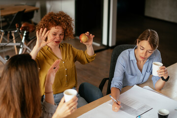 Businesswomen working on a new project. Colleagues discussing about problem they have to solved..