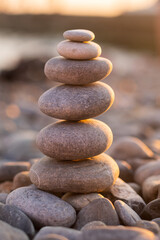 Zen pyramid of stones at sunset