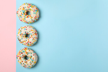 Tasty donuts on two tone background, top view