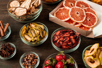 Above view of sweet and healthy various fruit snacks cooked into dehydrator placed on wooden table